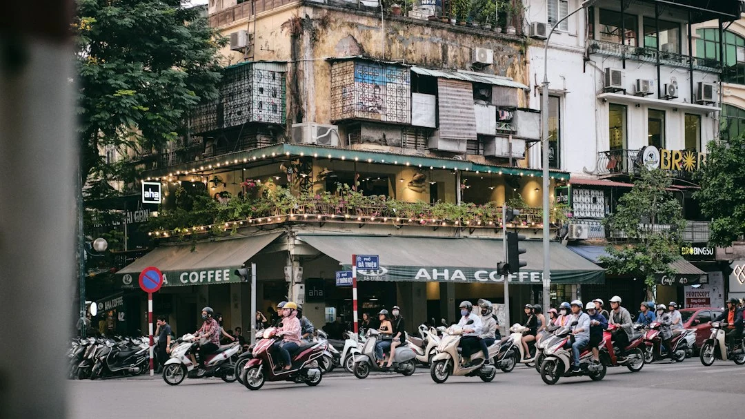 Motorbikes travelling on a Vietnamese urban street, illustration for 50cc moped rental guidance in Hanoi