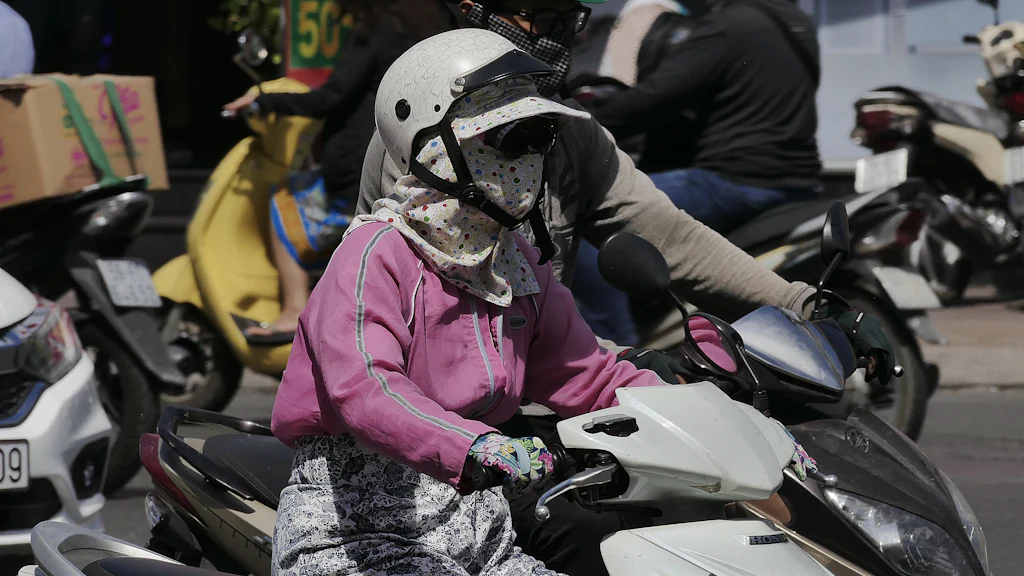 Traffic on a Vietnamese road illustrating the choice of a rental motorbike for commuting in Hanoi