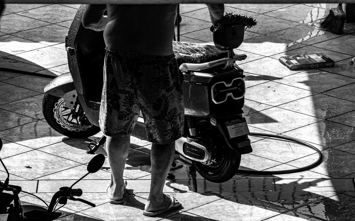 Person standing beside an electric scooter, illustration of comparing electric mobility options before a Hanoi rental