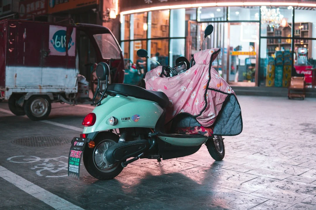 Green scooter parked by a street, illustration for deciding whether an electric motorbike fits Hanoi travel