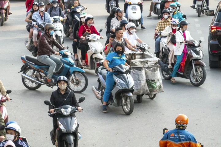 Motorbike traffic on a street junction in Hanoi, illustrating planning a three-day rental