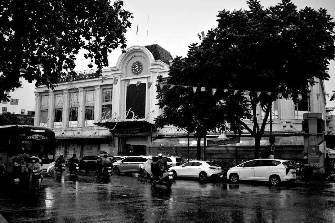 Schwarzweiß-Straßenszene mit Autos als Illustration zum Verkehrsmittelvergleich in Hanoi